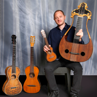 Fabricio Mattos with several guitars from the collection