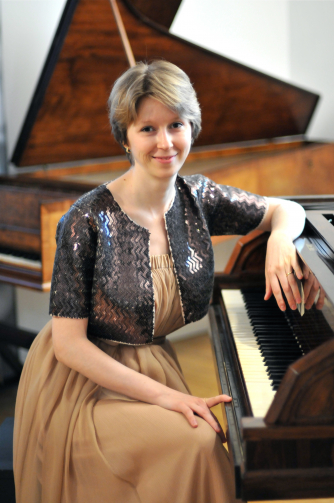Dr Elena Vorotko sitting at the piano