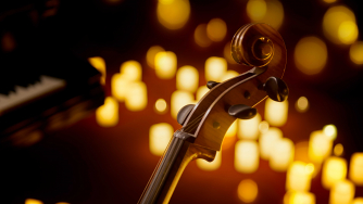 A string instrument in the gentle glow of candles A string instrument in the gentle glow of candles