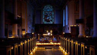 A piano surrounded by candles at our last concert