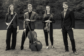 Members of Pocket Sinfonia standing holding flute, violin and cello