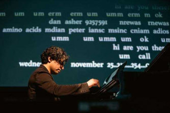 Zubin Kanga seated at the piano, with text projected onto a screen behind him. Zubin Kanga seated at the piano, with text projected onto a screen behind him.