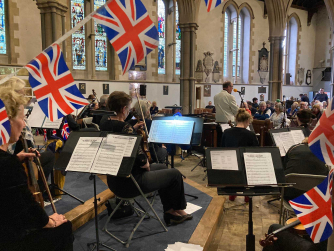 Members of Monmouth Concert Orchestra playing their instruments dressed in black Members of Monmouth Concert Orchestra playing their instruments dressed in black