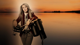 Evelyn Glennie holding percussion instruments in front of a Scottish loch Evelyn Glennie holding percussion instruments in front of a Scottish loch