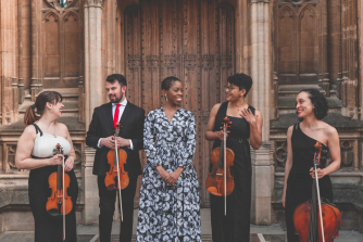 Samantha Ege stands in the middle of Castle of Our Skins string quartet