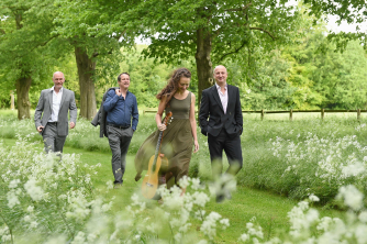 Vida Guitar Quartet walking through a garden Vida Guitar Quartet walking through a garden